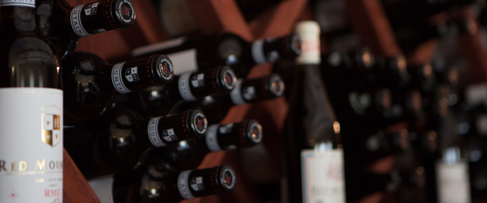 The front of the tasting bar bottle rack filled with wine bottles